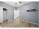 Bright bedroom featuring a ceiling fan, wood-look floors, and a closet at 2117 Bay Thrush Way, North Las Vegas, NV 89084