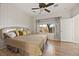 Comfortable bedroom featuring wood floors, a ceiling fan, and natural light from the window at 2117 Bay Thrush Way, North Las Vegas, NV 89084