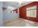 Bedroom with a window and gray accent wall and a red accent wall with a ceiling fan at 2117 Bay Thrush Way, North Las Vegas, NV 89084