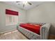 Bedroom featuring a red comforter, a window, and a light wood floor at 2117 Bay Thrush Way, North Las Vegas, NV 89084