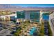 Aerial view of a community with resort-style amenities like a pool area and palm-lined entrance at 2117 Bay Thrush Way, North Las Vegas, NV 89084