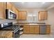 Stylish kitchen with stainless steel appliances, granite counters, and plentiful cabinets at 2117 Bay Thrush Way, North Las Vegas, NV 89084