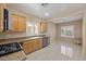 Efficient kitchen layout with natural wood cabinets, granite countertops, and lots of natural light at 2117 Bay Thrush Way, North Las Vegas, NV 89084