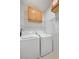 Functional laundry room with a white washer and dryer and ample storage cabinets at 2117 Bay Thrush Way, North Las Vegas, NV 89084