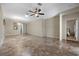 Spacious living room with a ceiling fan and view into an adjacent bedroom at 2117 Bay Thrush Way, North Las Vegas, NV 89084