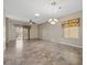Spacious living room with tile floors, ceiling fan, and natural light at 2117 Bay Thrush Way, North Las Vegas, NV 89084