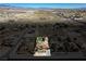 Aerial view showcases home's putting green, backyard, sparkling pool, and surrounding desert landscape at 2181 E Winery Rd, Pahrump, NV 89048
