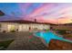 Stunning backyard with a sparkling pool, spa, and a spacious patio perfect for entertaining or relaxing in the sun at 2181 E Winery Rd, Pahrump, NV 89048