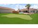 Expansive backyard featuring a lush lawn, putting green, rock features and a sparkling pool at 2181 E Winery Rd, Pahrump, NV 89048