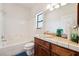 Clean bathroom with a tiled shower, vanity, and a bright window for natural light at 2181 E Winery Rd, Pahrump, NV 89048