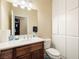 Clean bathroom features a dark wood vanity, white toilet, and built-in white storage cabinets at 2181 E Winery Rd, Pahrump, NV 89048