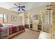 Comfortable bedroom featuring a ceiling fan and windows that provide natural light at 2181 E Winery Rd, Pahrump, NV 89048