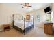 Bright bedroom with carpet, ceiling fan, backyard view, and decor at 2181 E Winery Rd, Pahrump, NV 89048