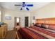 Inviting bedroom featuring wooden accents, warm tones, and a glimpse into the en-suite bathroom at 2181 E Winery Rd, Pahrump, NV 89048