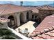 Aerial view of a beautiful courtyard with stone accents, a seating area, and lush greenery at 2181 E Winery Rd, Pahrump, NV 89048