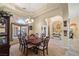 Formal dining room with a dark wood table, chandelier, and arched doorway into the entry at 2181 E Winery Rd, Pahrump, NV 89048