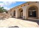 Home featuring arched windows, tile roof, and a stamped concrete patio with outdoor seating and desert landscaping at 2181 E Winery Rd, Pahrump, NV 89048