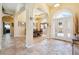 Open foyer with arched doorways, tile flooring, and a dining area bathed in natural light at 2181 E Winery Rd, Pahrump, NV 89048