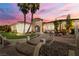 Elegant home featuring a stone tower entrance, lush landscaping, and a beautifully designed walkway leading to the front door at 2181 E Winery Rd, Pahrump, NV 89048
