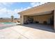 Spacious garage with ample storage space, showcasing its functionality and access to the backyard pool area at 2181 E Winery Rd, Pahrump, NV 89048
