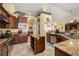 Charming kitchen with wood cabinets, granite counters, stainless appliances and adjacent breakfast nook at 2181 E Winery Rd, Pahrump, NV 89048