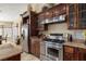 Well-equipped kitchen features stainless steel appliances and custom wood cabinetry at 2181 E Winery Rd, Pahrump, NV 89048