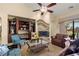 Cozy living room with a fireplace, built-in shelves, and sliding glass doors to the pool area at 2181 E Winery Rd, Pahrump, NV 89048