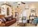 Open living room layout with leather furniture, arched doorways, and view into the kitchen and dining areas at 2181 E Winery Rd, Pahrump, NV 89048
