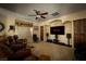 Cozy living room features tiered seating, ceiling fan, and media center for relaxed home entertainment at 2181 E Winery Rd, Pahrump, NV 89048