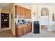 Living room with coffee bar featuring dark wood cabinets and mini fridge, enhancing the entertainment space at 2181 E Winery Rd, Pahrump, NV 89048