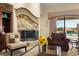 Comfortable living room with fireplace, leather seating, and a view of the pool area through a window at 2181 E Winery Rd, Pahrump, NV 89048
