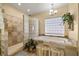 Well-lit main bathroom with a separate shower and large soaking tub at 2181 E Winery Rd, Pahrump, NV 89048