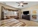 Bright main bedroom featuring neutral-toned walls, ceiling fan, and a door leading to an outside patio at 2181 E Winery Rd, Pahrump, NV 89048
