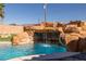 Close-up of the rock waterfall feature that enhances the beauty of the custom-built pool at 2181 E Winery Rd, Pahrump, NV 89048