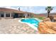 Expansive pool and spa area, complemented by lush landscaping and a covered patio at 2181 E Winery Rd, Pahrump, NV 89048
