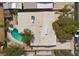 Top-down aerial view of a private pool and the property's roof against a background of lush greenery and neighborhood views at 2408 Berkley Ave, Las Vegas, NV 89101