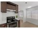 Stylish kitchen with dark wood cabinets and stainless steel appliances at 2408 Berkley Ave, Las Vegas, NV 89101