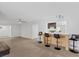 Spacious living room with bar seating, tile floors, and modern ceiling fan at 2408 Berkley Ave, Las Vegas, NV 89101