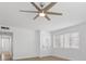 Inviting living room with wood-look tile floors, ceiling fan, and large windows at 2408 Berkley Ave, Las Vegas, NV 89101