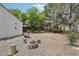 This backyard offers a fire pit, mature trees, and plenty of shade to relax at 3201 Beacon Shores Cir, Las Vegas, NV 89117
