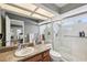 Bathroom featuring a shower-tub combo, granite countertops, and natural lighting at 3201 Beacon Shores Cir, Las Vegas, NV 89117