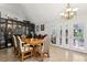 Elegant dining room featuring hardwood floors, stylish lighting, and doors to the yard at 3201 Beacon Shores Cir, Las Vegas, NV 89117