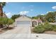 Charming single-story home with a well-manicured lawn and a two-car garage at 3201 Beacon Shores Cir, Las Vegas, NV 89117