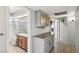 Hallway leading to bathroom featuring vanity and tile countertops at 3201 Beacon Shores Cir, Las Vegas, NV 89117