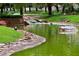 Tranquil pond featuring lush landscaping, rock borders, and a duck, creating a serene outdoor retreat at 3201 Beacon Shores Cir, Las Vegas, NV 89117
