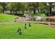 Charming pond scene with ducks on the grassy bank, surrounded by mature trees and manicured lawns at 3201 Beacon Shores Cir, Las Vegas, NV 89117