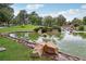 Picturesque pond surrounded by green grass, trees, and rock borders, offering a serene outdoor setting at 3201 Beacon Shores Cir, Las Vegas, NV 89117