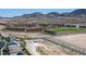 A beautiful aerial view showcasing community parks, tennis courts, and sports fields against a mountain backdrop at 3484 Bradano Ln, Henderson, NV 89044