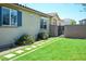 Backyard with lush green lawn and concrete paver walkway and block wall at 3484 Bradano Ln, Henderson, NV 89044