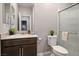 Bathroom featuring vanity with large mirror, wood cabinets, and a glass-enclosed shower at 3484 Bradano Ln, Henderson, NV 89044
